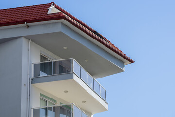 An open balcony located on the top floor of a residential building.