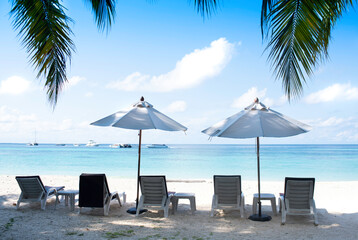 Five chairs and two white umbrella on the beach. Banner, lots of copy space