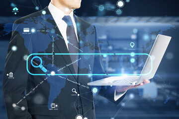 Close up of businessman hand holding laptop with creative search bar and digital blue map icons on blurry office interior background. Address and Url concept. Double exposure.