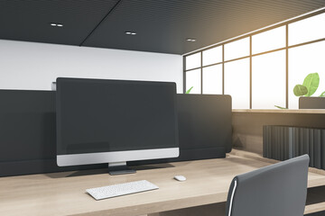 Close up of empty computer monitor in coworking office interior with wooden desk and bright city view. Mock up, 3D Rendering.