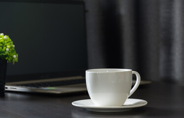 Coffee cup on work table,soft focus.