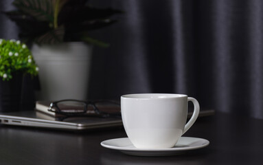Coffee cup on work table,soft focus.