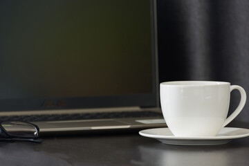 Coffee cup on work table,soft focus.