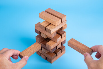 Hand of man piling up and stacking a wooden block. Plan and strategy in business, Risk To Make Business Growth Concept