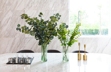 Bunch of eucalyptus branches  in vase on dining table table