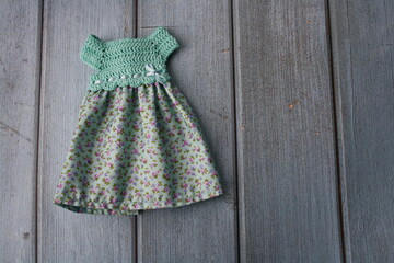 Crochet dress for a doll made of cotton yarn . Home needlework made of thread.