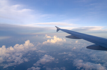 Obraz premium Aerial view over white puffy clouds horizon background. Beautiful sky and cloud texture view from airplane.