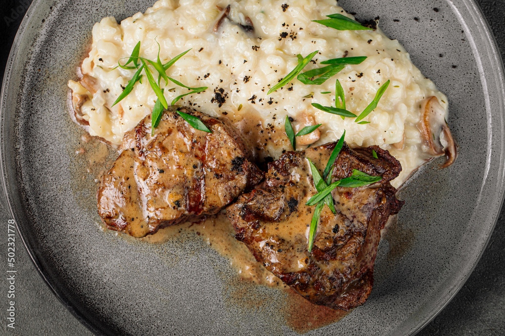 Wall mural closeup on mignon steak with risotto garnish