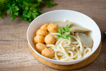 Udon, Shrimp Balls, and Fish Balls in Clear Soup Japanese Cuisine in a white porcelain cup