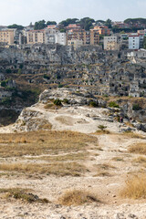 Obraz premium Panoramic view of Sassi di Matera a historic district in the city of Matera, well-known for their ancient cave dwellings from the Belvedere di Murgia Timone, Basilicata, Italy