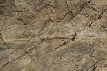 Texture of massif of natural clay shale. Surface of slate rock is cut by diagonal cracks, abstract background, high resolution.