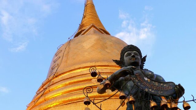Tilt Up Shot Of Black Statue By Wat Saket Temple - Bangkok, Thailand