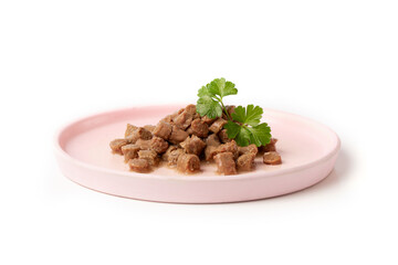 Delicious wet food for a cat or dog, pieces of nutritious meat for an animal, dog or cat in a plate on a white background.