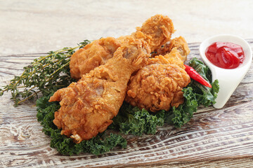 Fried chicken drumsticks with tomato sauce