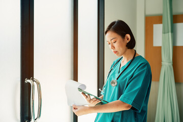 Portrait of doctor or nurse examining senior male patient in hospital room.