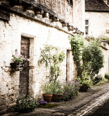 Pots Of Plants Outside A Residential Street In Medieval Issigeac, Dordogne, France