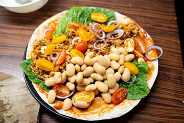 Mexican Tortilla with Tomato Salsa, Avocado, Beans, Beaf Meat, Corn, Tomato, Lettuce and Onion.