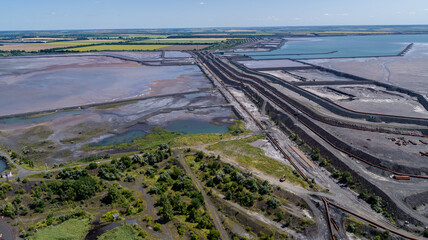 Tailings dump are the materials left over after the process of separating the valuable fraction from the uneconomic fraction gangue of an ore aerial view - obrazy, fototapety, plakaty
