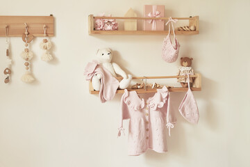 Children's knitted clothes on hanger. Jacket, jumper, hat, shoes. toys. Children's room, nursery