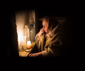 Frightened woman hide from explosions in the basement. During the sirens due to the shelling of...