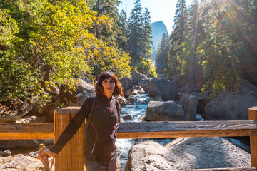 A woman in Vernal Falls waterfall of Yosemite National Park. California