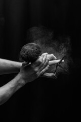 barber is holding a brush for powder hairdresser and scissor