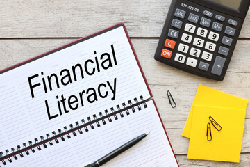 FINANCIAL LITERACY. text on planner page on light table