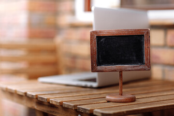 Empty wooden plate on wooden table in a restaurant, copy space for example reserved. High quality photo