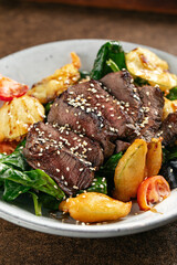 Closeup on roast beef dish with vegetables garnish