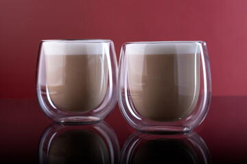 cappuccino in glass cup with double walls on board