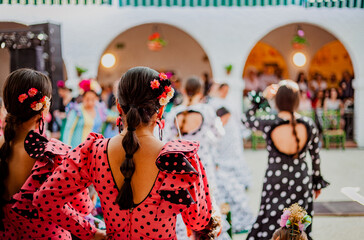 spanish woman dressed as sevillanas at a traditional festival in Rota, Spain