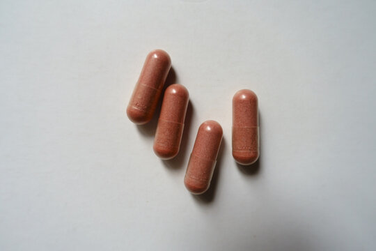 4 pink capsules of PQQ dietary supplement from above