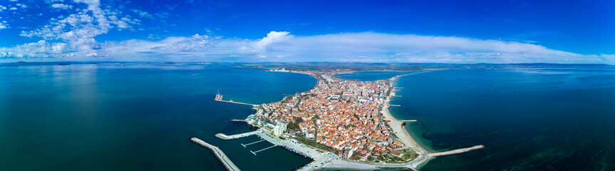 Naklejka premium Panoramic view from a height above the town of Pomorie with houses and streets washed by the Black Sea in Bulgaria