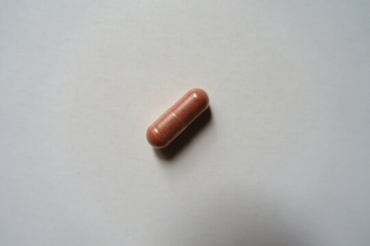 Pink capsule of PQQ dietary supplement from above