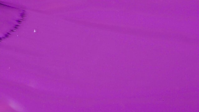 Violet gel nail polish. brush movement. Manicure cover