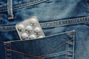 medical pill blister at jeans pocket,  opaque blister pack of pills in jeans pocket