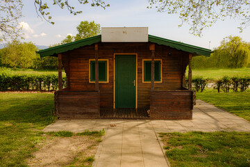 Fototapeta na wymiar small wooden house in a public park, late spring