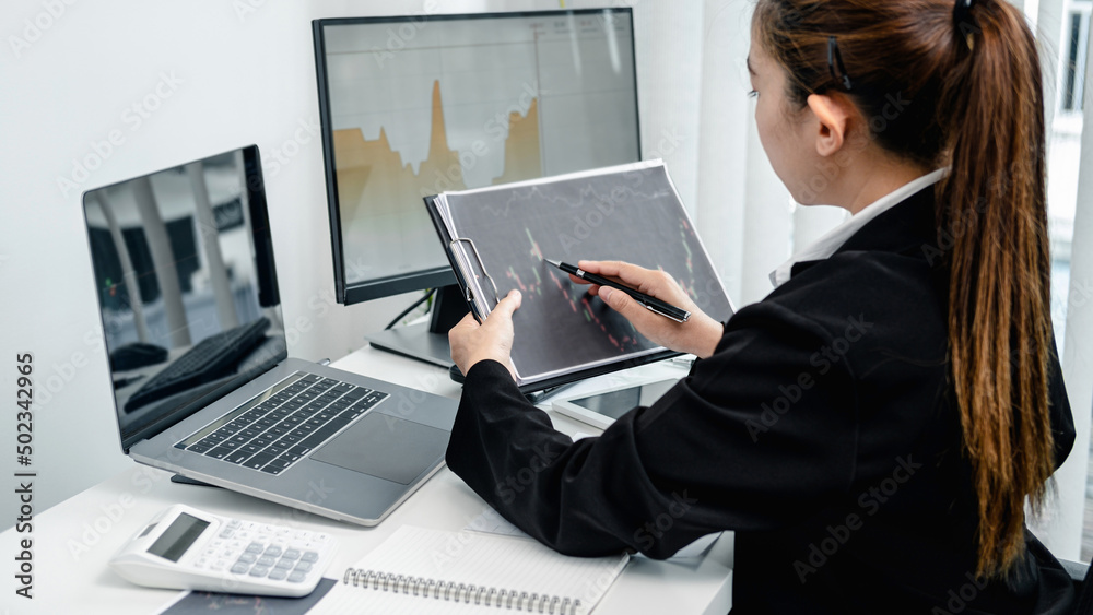 Aufkleber businesswoman is pointing stock data chart to taking note on document and checking data of stock exc