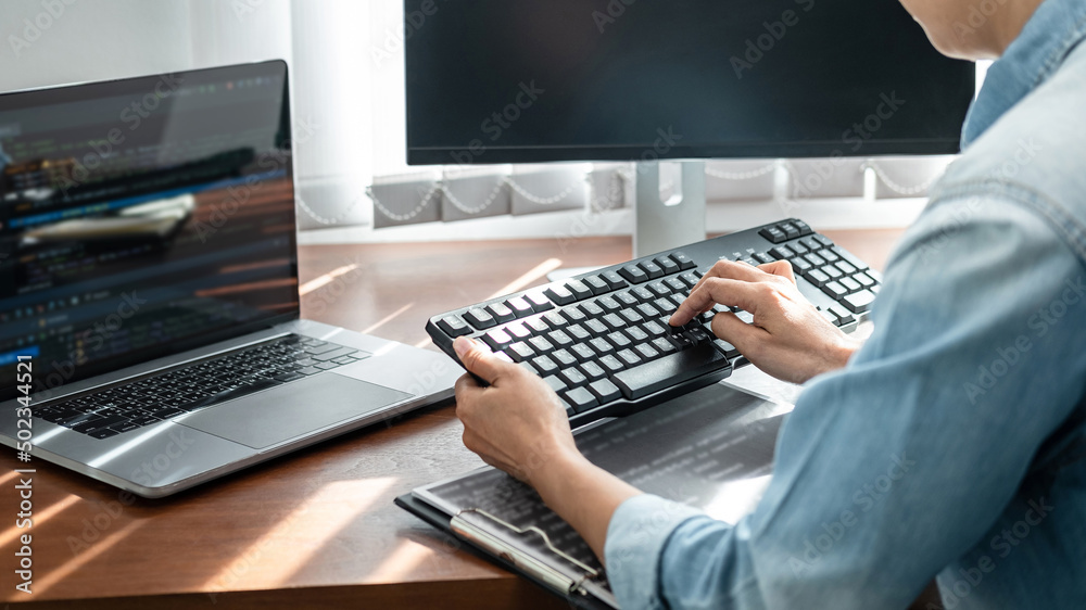 Aufkleber Asian woman programmer looking on keyboard to typing code data about new project on laptop while working