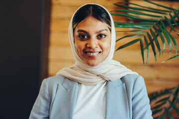 Portrait of a Muslim businesswoman wearing a hijab in an office