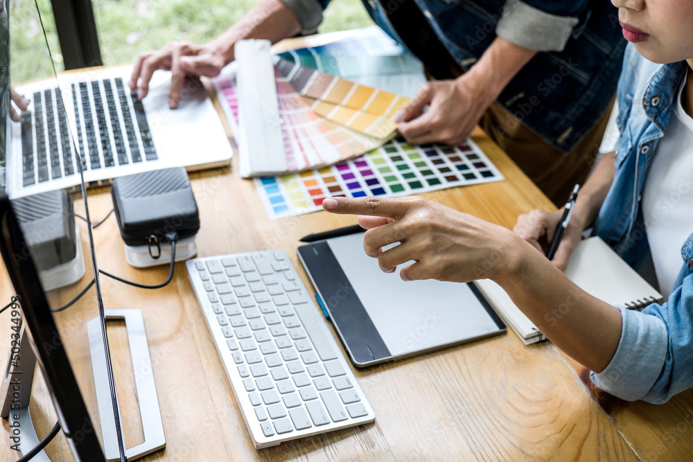 Poster Two colleagues creative graphic designer working on color selection and drawing on graphics tablet at workplace, Color swatch samples chart for selection coloring