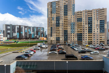 Parking for cars in the courtyard of the district of modern high-rise residential buildings in St....