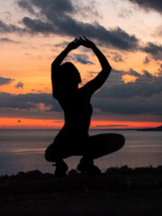 Fototapeta premium A girl posing during a sunset with ocean