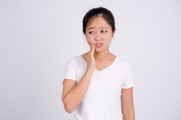 Portrait of asian female feeling painful toothache. Teeth problem woman feeling tooth pain. Dental healthcare concept.