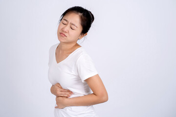 Health issues problems concept. Woman suffering from stomach pain, feeling abdominal pain or cramps, isolated on white background.