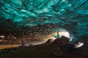 Explorer inside an ice cave in Iceland