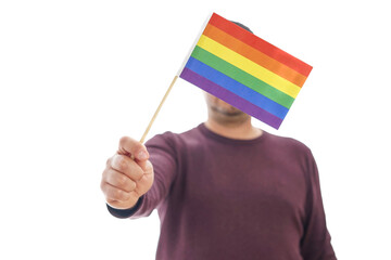 Unrecognizable mature man holds flag with colors of LGBTQ movement on white background. Concept of tolerance, inclusion and diversity. High quality photo