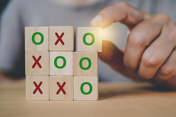 senior hand arranged wooden cube blocks, tic tac toe XO game, for business strategy, success concept