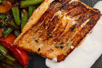 Closeup on grilled salmon steak with vegetables