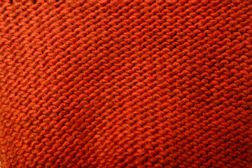 Knit red fabric texture, background or backdrop. Textile, scarf or sweater textured surface, back...